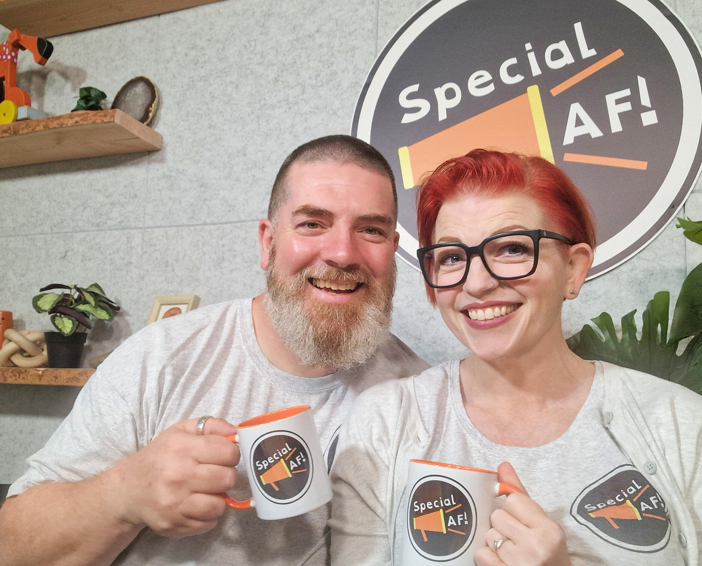 Special AF! podcast An image of a bearded man and a red-haired woman smiling sitting at a podcast desk